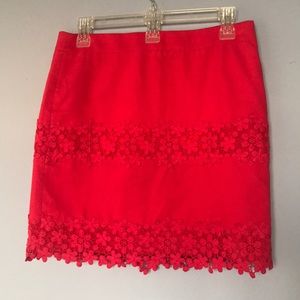 Deep coral colored skirt with embroidered trim